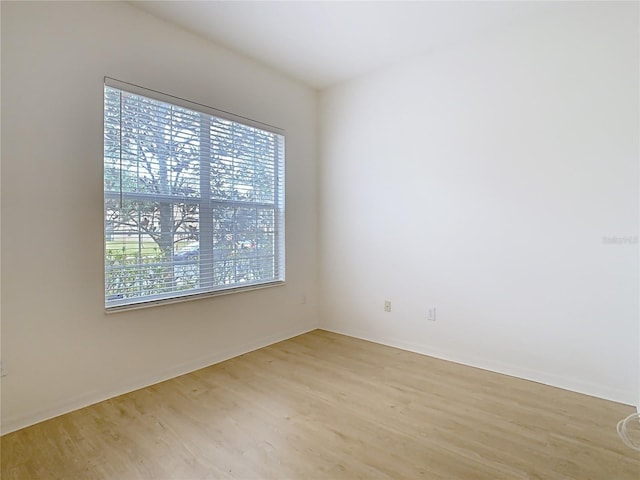 empty room with light hardwood / wood-style flooring