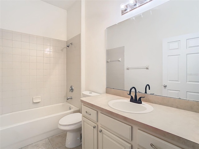 full bathroom with tiled shower / bath, tile patterned floors, vanity, and toilet