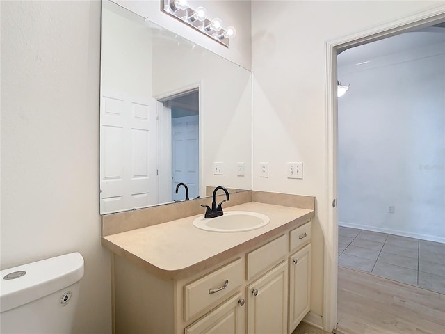 bathroom featuring vanity, toilet, and tile patterned floors