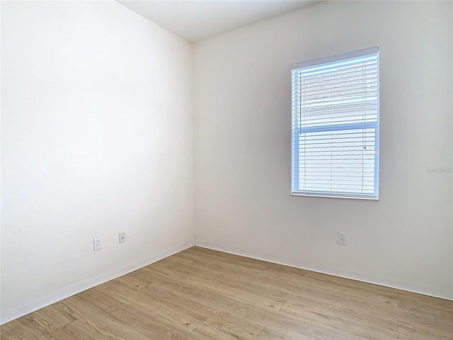 empty room with light hardwood / wood-style flooring