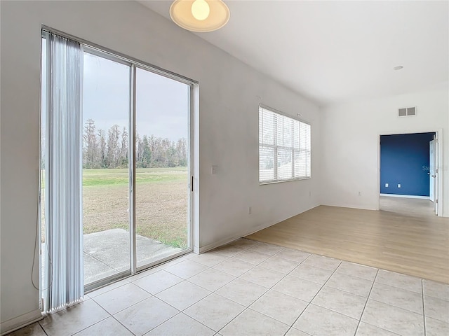 unfurnished room with light tile patterned floors