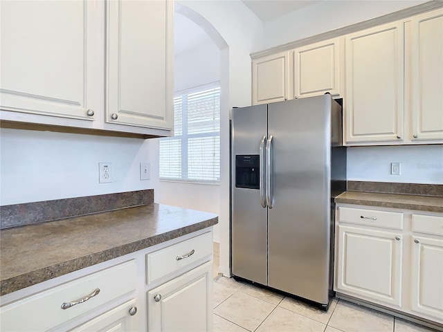 kitchen featuring light tile patterned floors, white cabinetry, and stainless steel fridge