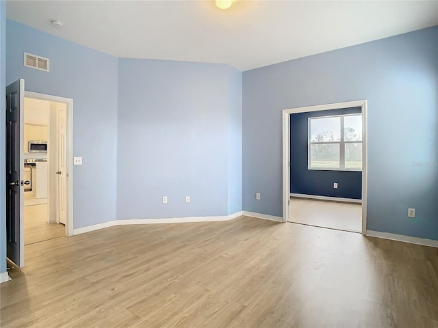 spare room featuring light hardwood / wood-style flooring