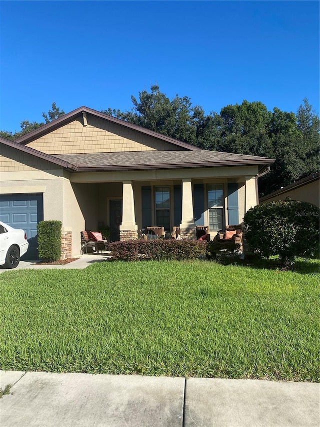 view of front of home with a front lawn and a garage