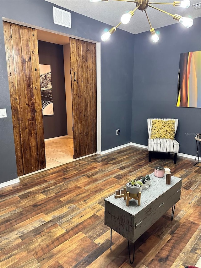 living area featuring hardwood / wood-style flooring and a textured ceiling