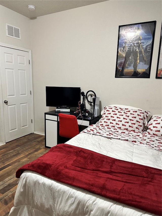 bedroom featuring dark hardwood / wood-style flooring