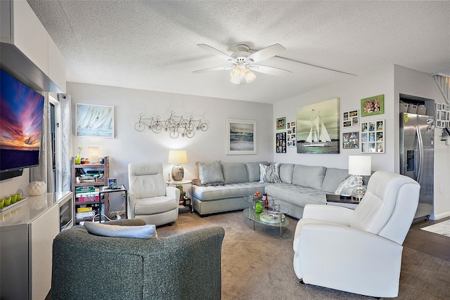 living room featuring carpet flooring, a textured ceiling, and ceiling fan