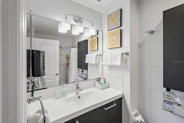 bathroom featuring toilet, vanity, decorative backsplash, and a shower with shower curtain