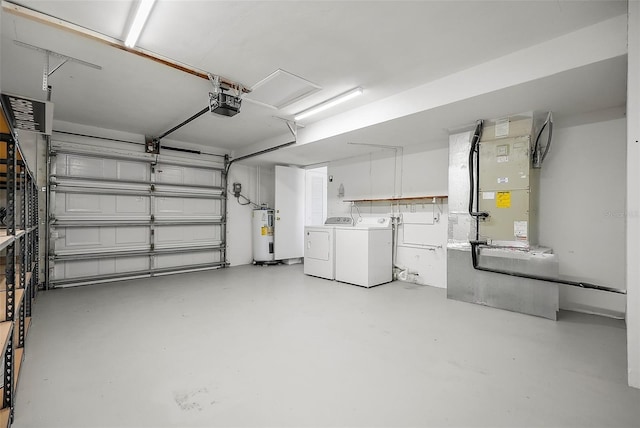 garage with washer and clothes dryer, a garage door opener, and water heater