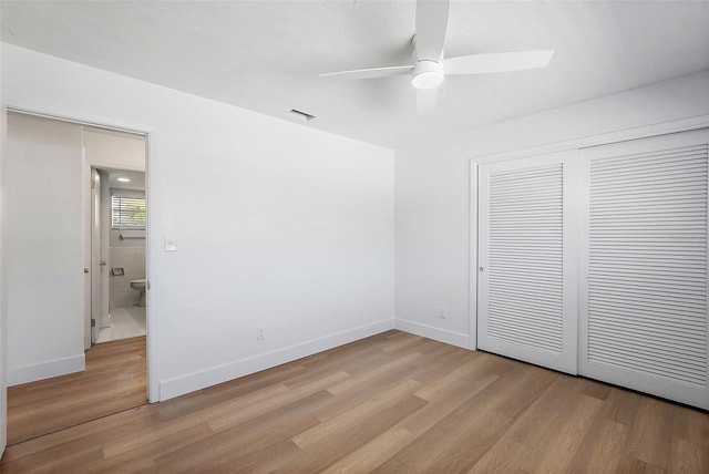 unfurnished bedroom with light wood-type flooring, a closet, and ceiling fan