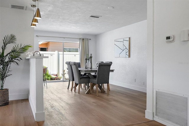 dining area with hardwood / wood-style floors