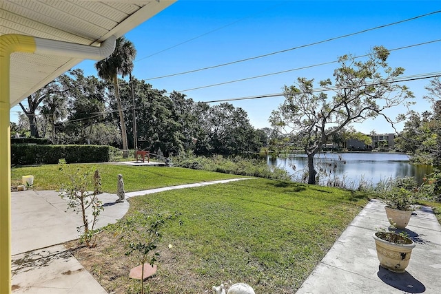 view of yard with a water view and a patio