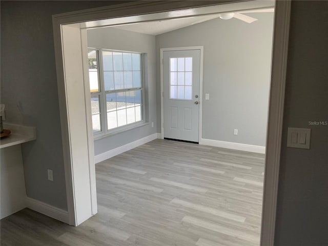 doorway to outside with light hardwood / wood-style flooring, lofted ceiling, and ceiling fan