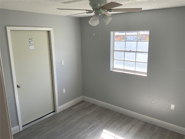 interior space with a textured ceiling, wood-type flooring, and ceiling fan