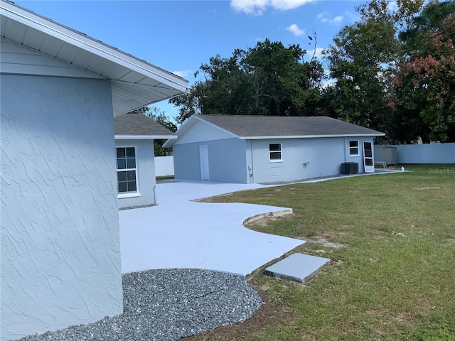 view of yard featuring central air condition unit and a patio area