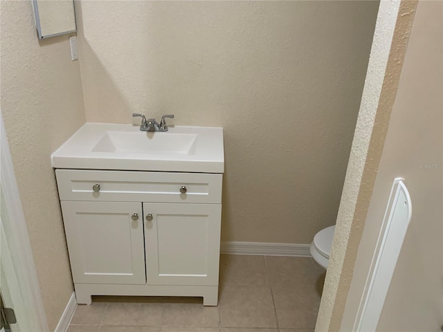 bathroom featuring vanity, toilet, and tile patterned floors