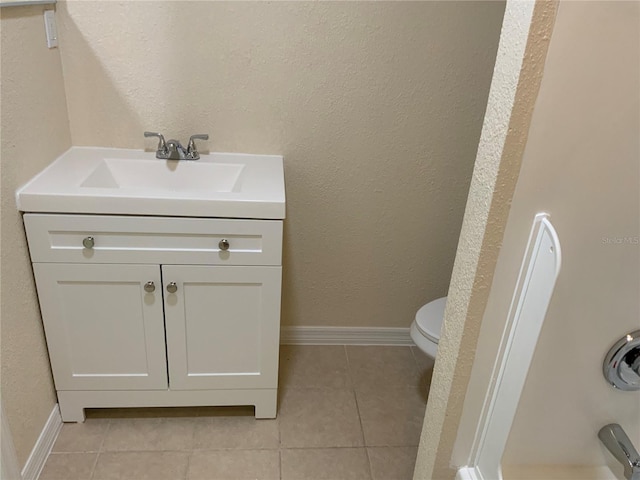 bathroom with vanity, toilet, and tile patterned flooring