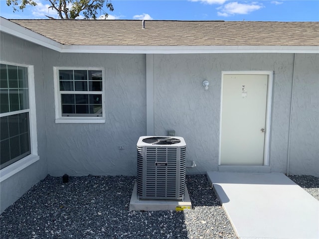 view of exterior entry with central air condition unit