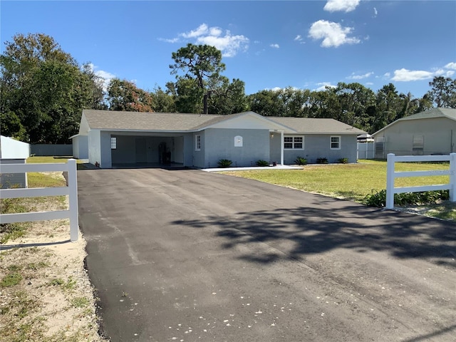 single story home with a garage and a front lawn