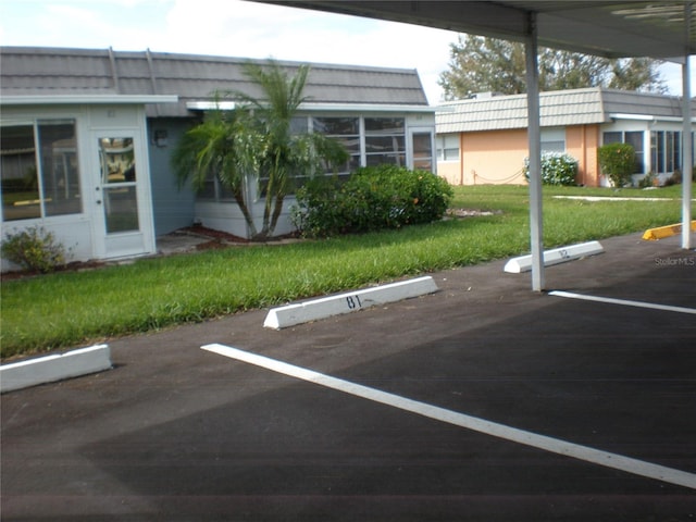 view of car parking featuring a lawn