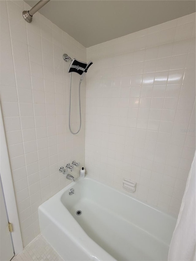 bathroom with tile patterned floors and shower / bathtub combination with curtain