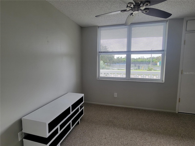 interior space with a textured ceiling and ceiling fan