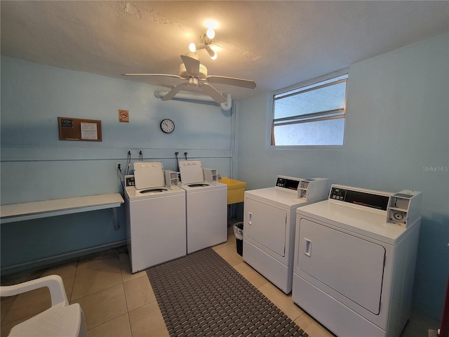 laundry room with a textured ceiling, ceiling fan, washer and clothes dryer, and light tile patterned floors