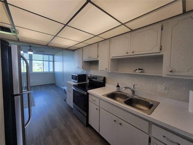 kitchen with white cabinets, ceiling fan, appliances with stainless steel finishes, dark wood-type flooring, and sink