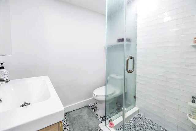 bathroom featuring vanity, tile patterned floors, toilet, and walk in shower