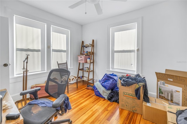 home office featuring wood-type flooring and ceiling fan