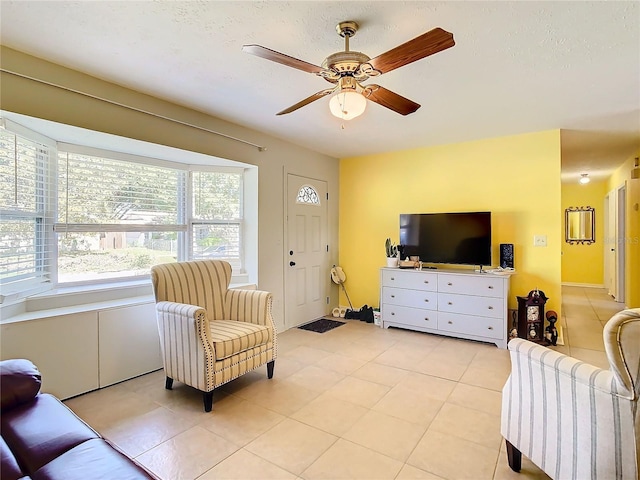 tiled living room with ceiling fan