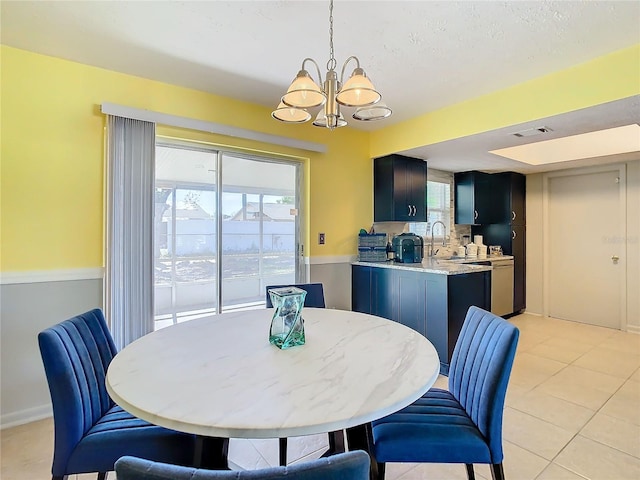 tiled dining room featuring a notable chandelier and sink