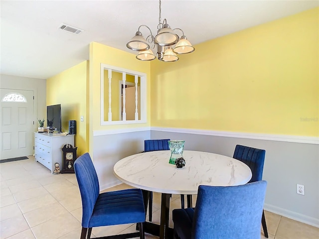 tiled dining area with a notable chandelier