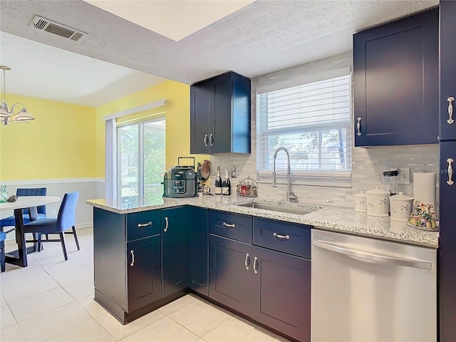 kitchen with light stone countertops, tasteful backsplash, stainless steel dishwasher, and sink