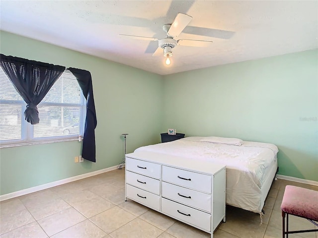 tiled bedroom featuring ceiling fan