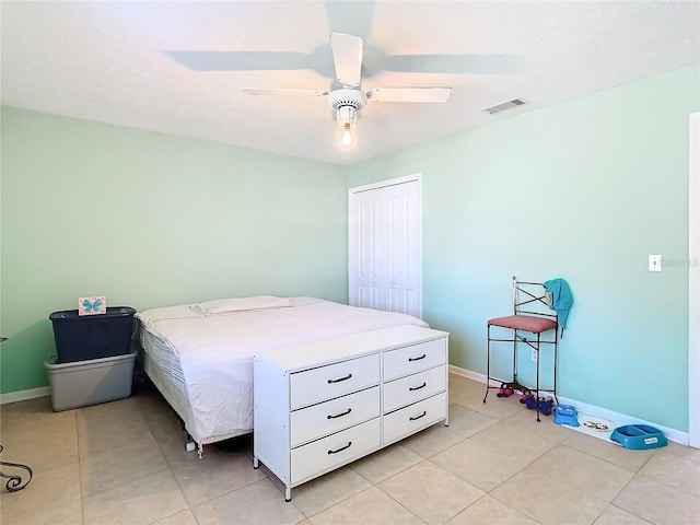 tiled bedroom with a closet and ceiling fan