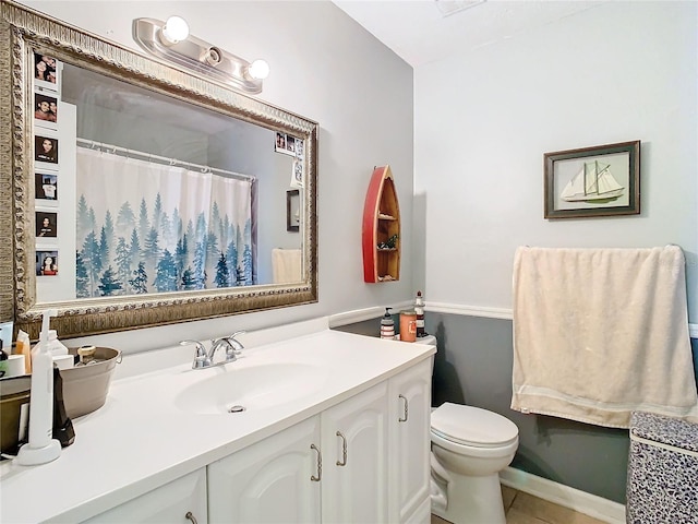 bathroom with vanity, toilet, and tile patterned flooring