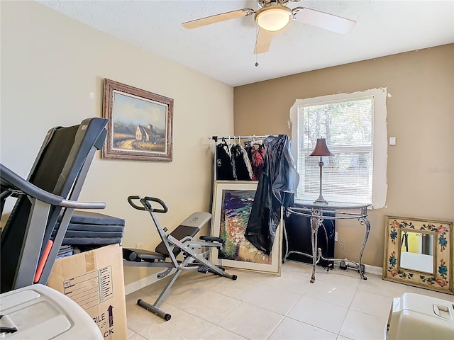 workout room featuring light tile patterned floors and ceiling fan