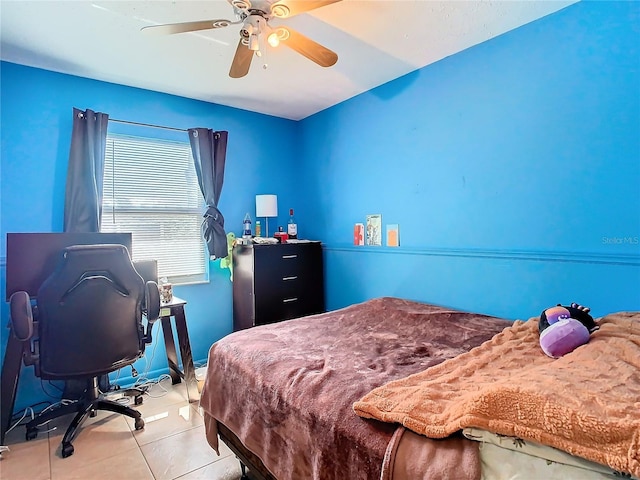 bedroom with ceiling fan and light tile patterned floors