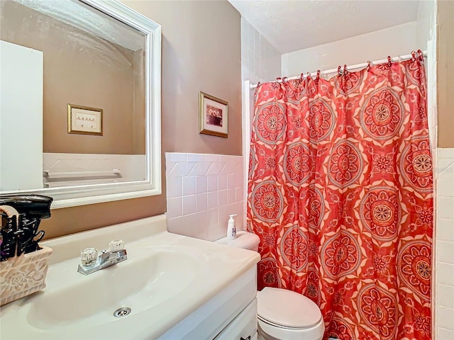 bathroom featuring vanity, toilet, and walk in shower