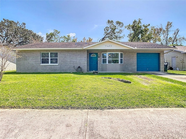 ranch-style home with a garage and a front lawn