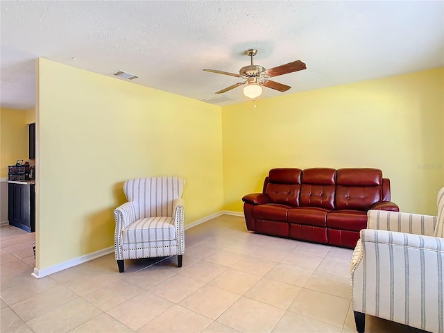 living room featuring a textured ceiling and ceiling fan