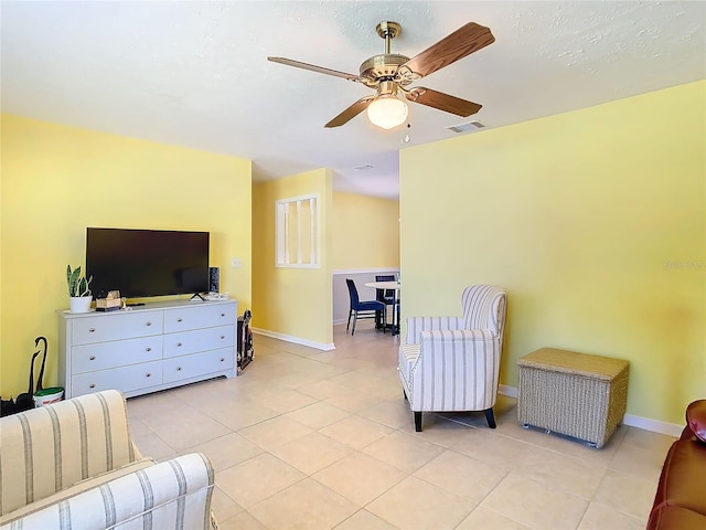 tiled living room with ceiling fan