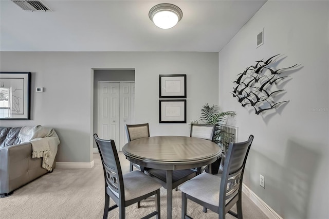 dining room featuring light colored carpet