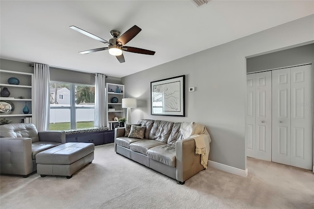 living room with ceiling fan and light colored carpet