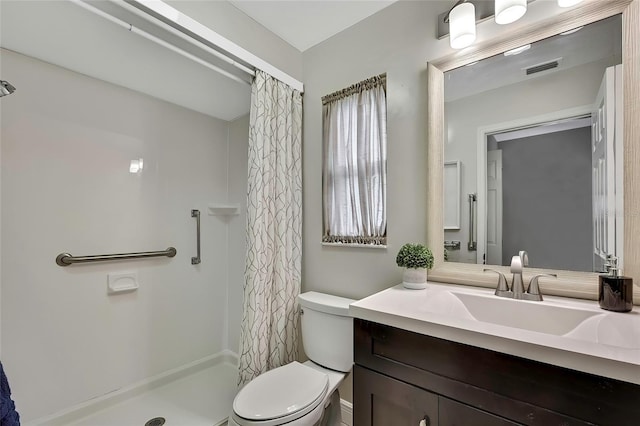 bathroom featuring vanity, curtained shower, and toilet