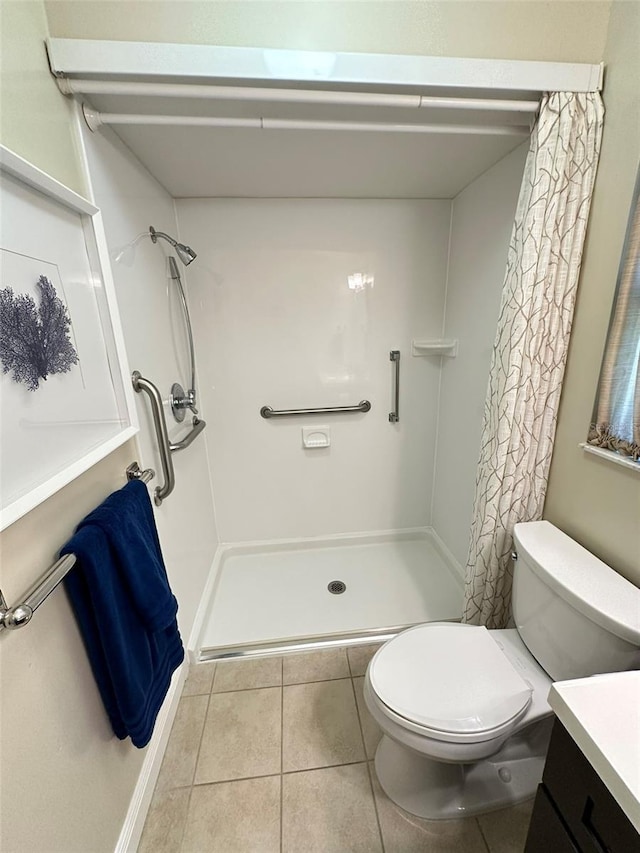 bathroom with tile patterned flooring, vanity, toilet, and curtained shower