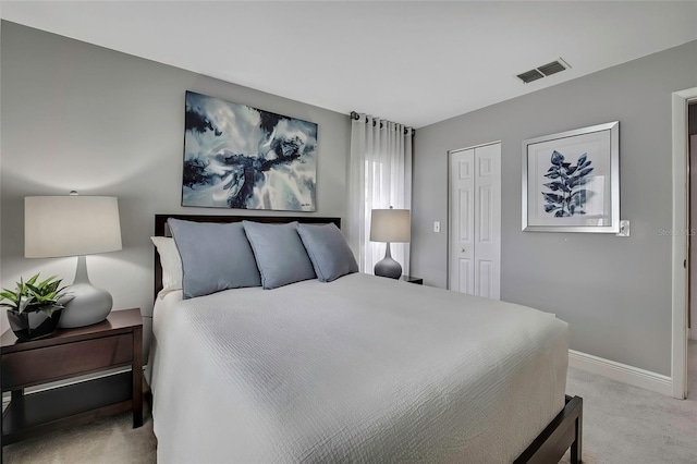 bedroom featuring light carpet and a closet