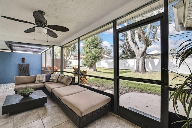 sunroom / solarium featuring ceiling fan