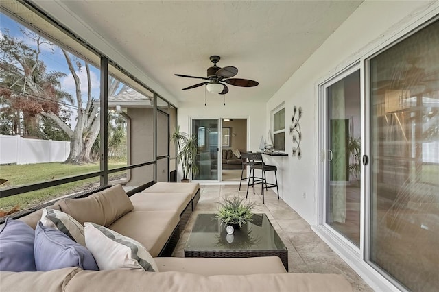 sunroom featuring ceiling fan